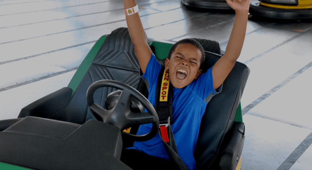 Boy cheering while on go-kart